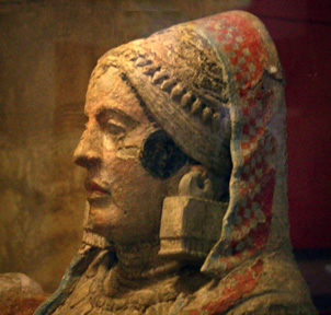 matured woman with rich headdress and jewelry, painted stone