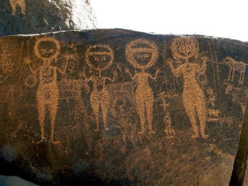 round-headed women with upraised hands, boulder petroglyph