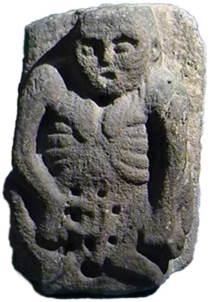 old woman, hairless, bony, with hand to vulva, and a circle of hollows in the stone surrounding vulva and womb