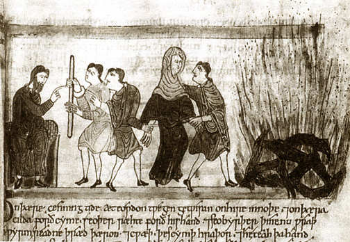 men leading veiled woman to a burning pyre, her feet off the ground