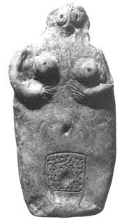 rough clay figurine of woman clasping breasts, with large dotted vulva